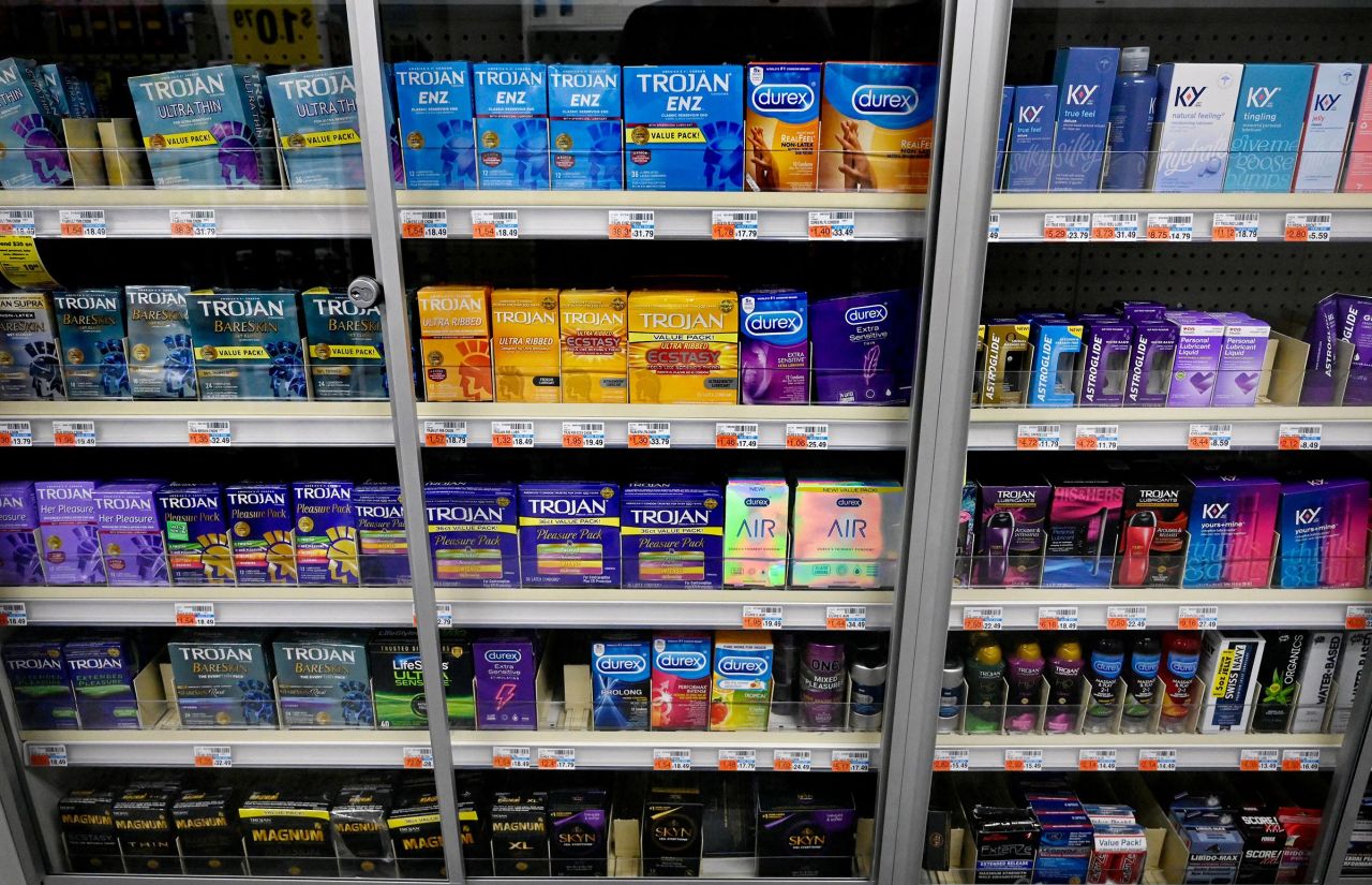 This February 2022 photo shows packs of various condoms on a shelf of a convenience store in Washington, DC.