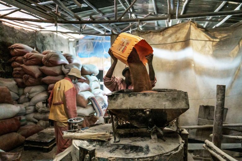 A man loads a mill with teff grain in the city of Addis Ababa, Ethiopia.