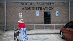 In this 2022 photo, a woman walks into a Social Security office in Houston.