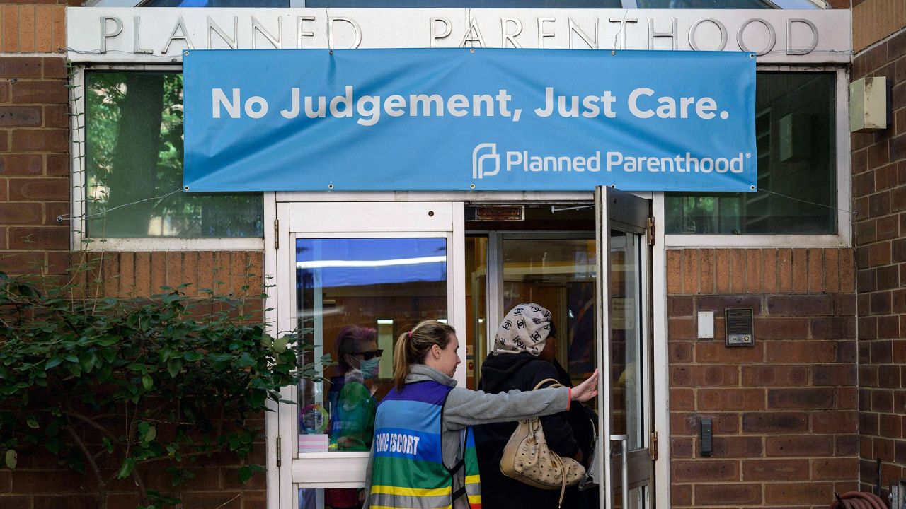 In this September 2022 photo, a clinic escort assists a patient at a Planned Parenthood Health Center in Philadelphia.