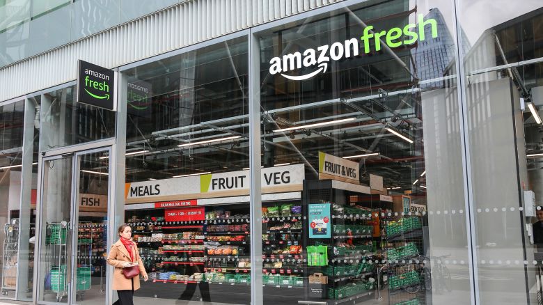 A woman walks past a an Amazon Fresh store in central London on April 19, 2023.