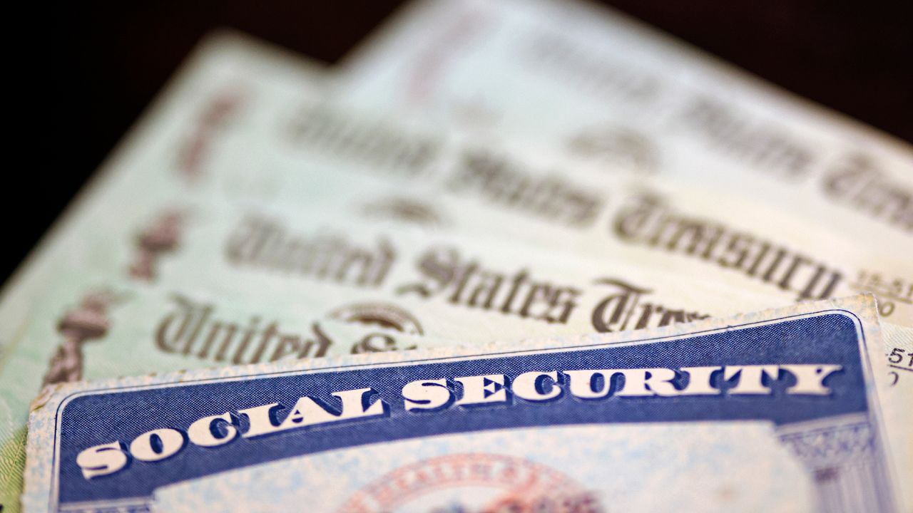 A Social Security card sits alongside checks from the US Treasury on October 14, 2021 in Washington, DC.