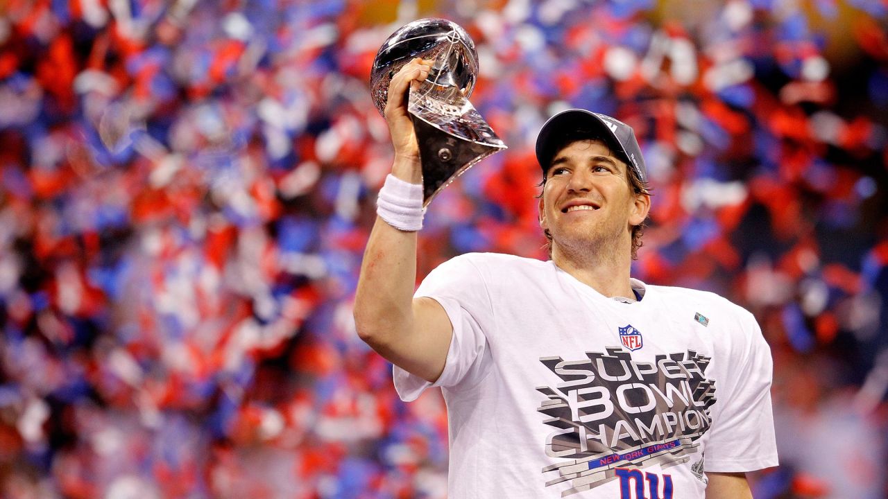 Quarterback Eli Manning of the New York Giants poses with the Vince Lombardi Trophy after the Giants defeated the Patriots by a score of 21-17 in Super Bowl XLVI at Lucas Oil Stadium on February 5, 2012 in Indianapolis, Indiana. 