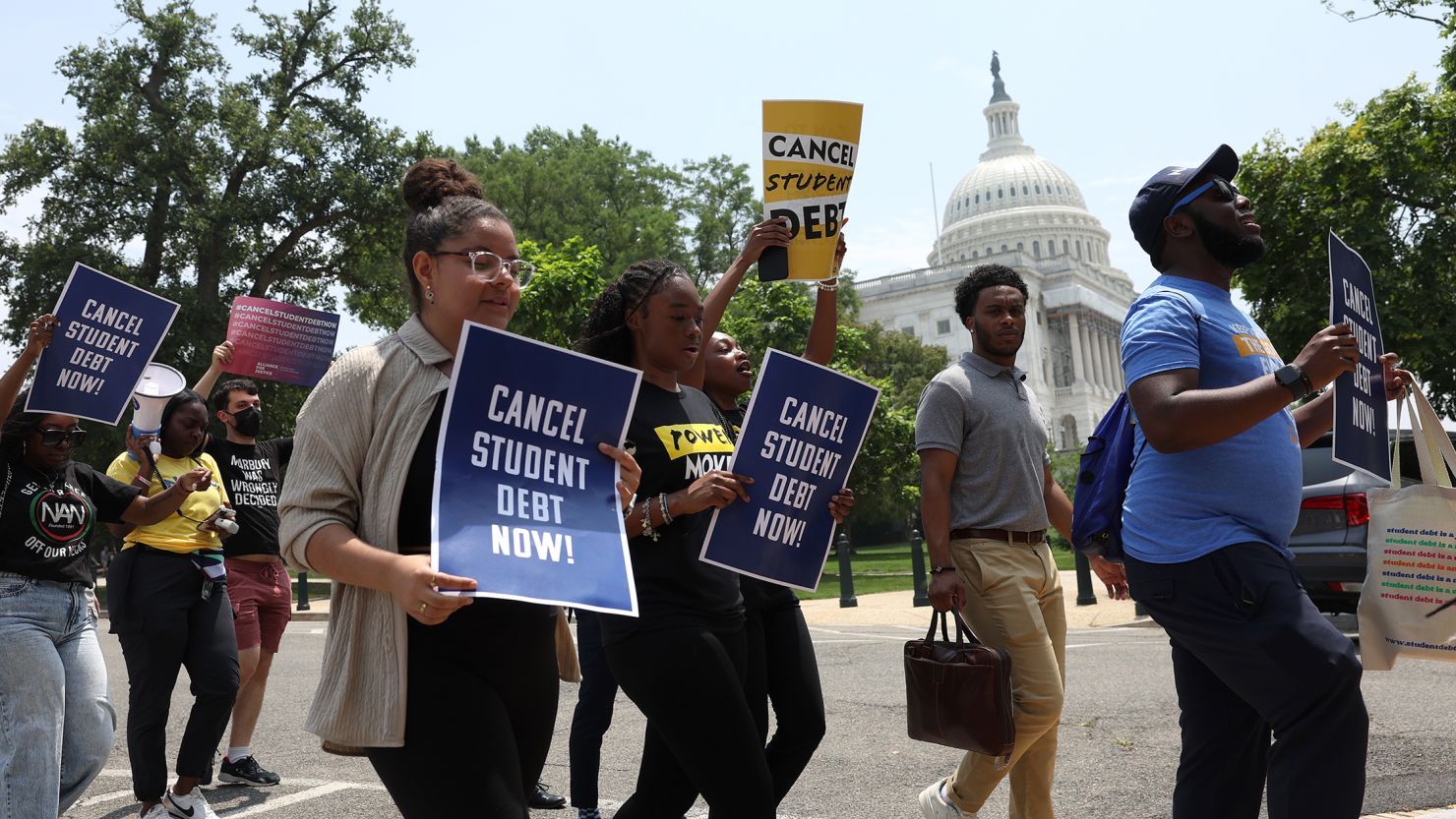Student debt relief activists participate in a rally as they march from the US Supreme Court to the White House.