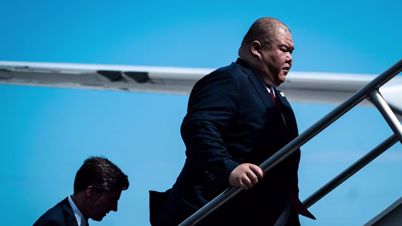 Steven Cheung follows former President Donald Trump as they board his plane to fly back to New Jersey on June 13 in Miami.
