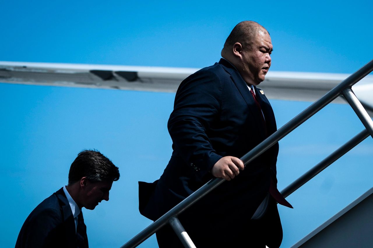 Steven Cheung follows former President Donald Trump as they board his plane to fly back to New Jersey on June 13 in Miami.