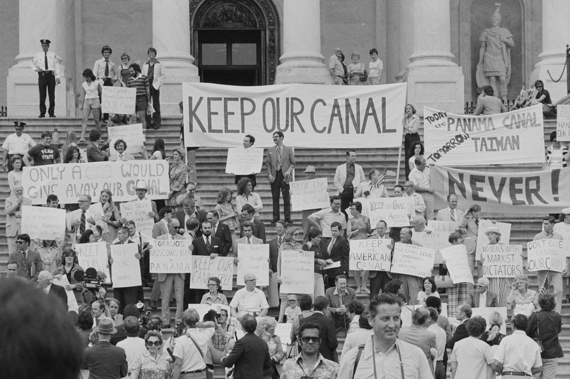 In this 1977 photo, demonstrators, many with signs and banners protesting a treaty to return control of the Panama Canal to Panama, are gathered on the steps of the east entrance of the US Capitol building in Washington, DC.