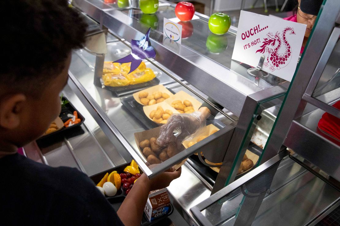 A students picks up lunch at the cafeteria at an elementary school in Virginia in August 2023.