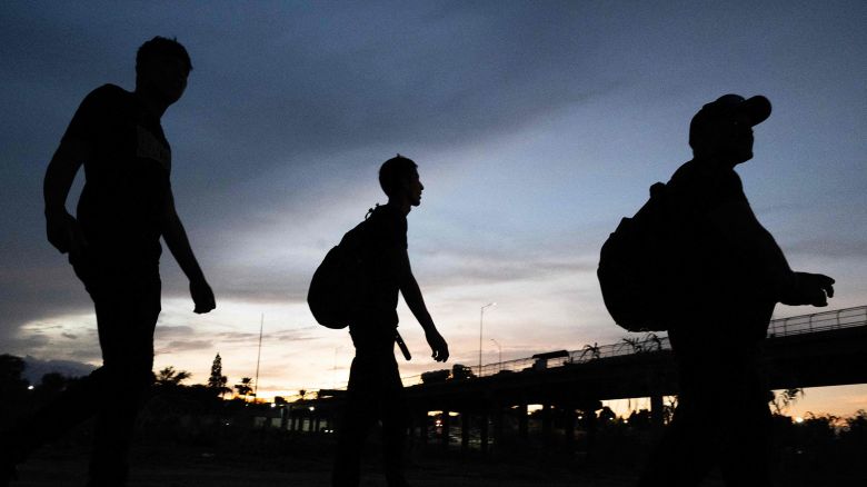 Venezuelans walk to a US Border Patrol processing center after they crossed the Rio Grande river and over the razor wire to cross into Eagle Pass, Texas on September 25, 2023.