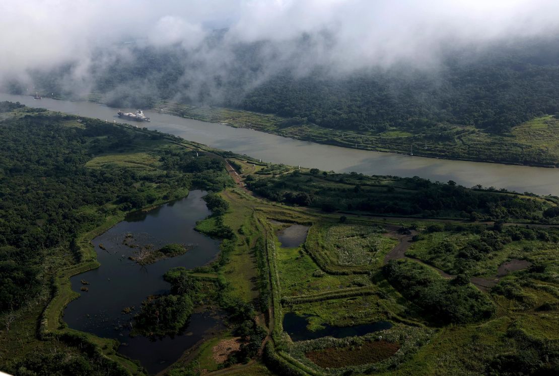 A tugboat assists a ship as it navigates the Chagres River while it transiting through the Panama Canal on September 20, 2023 in Gamboa, Panama.