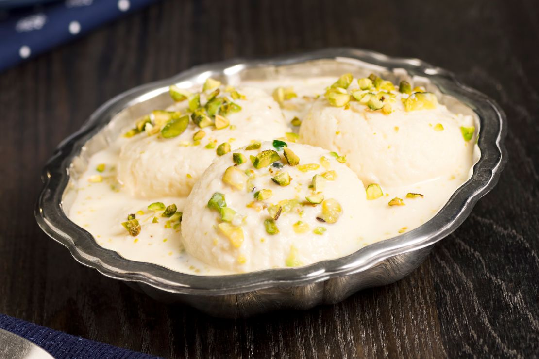 Rasmalai (or Ras Malai) is a Bengali dessert made from soft paneer cheese balls soaked in sweet milk which is flavored with saffron or cardamom. It is topped with crushed or sliced pistachio nuts.