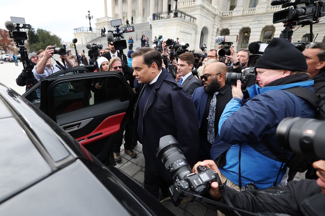Rep. George Santos is surrounded by journalists as he leaves the US Capitol after his fellow members of Congress voted to expel him from the House of Representatives on December 1, 2023.