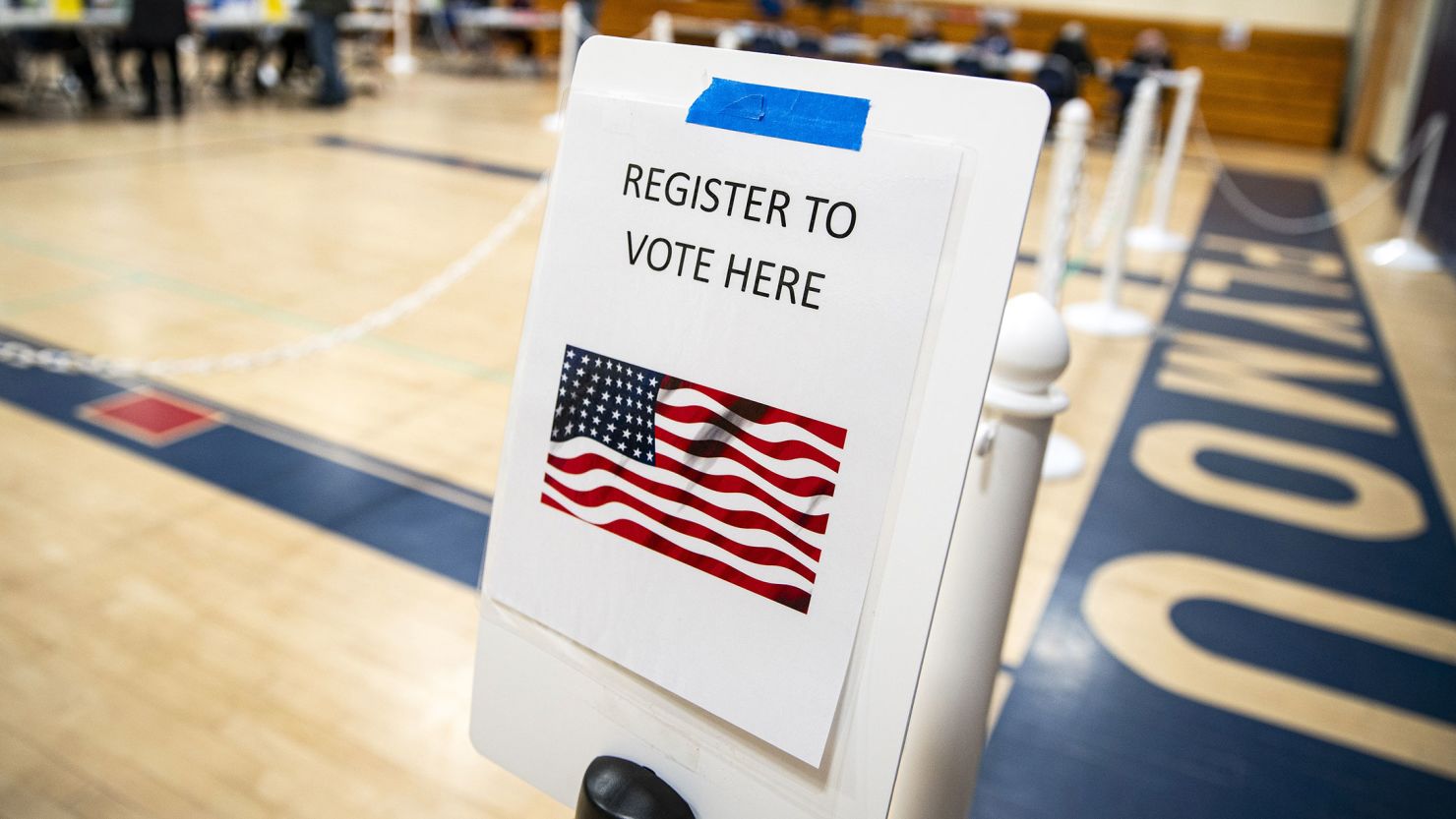 A sign to register to vote at a polling station inside Plymouth Elementary School in Plymouth, New Hampshire, on January 23. 