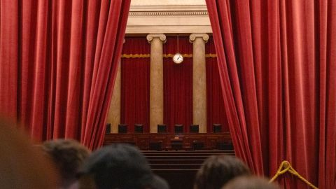 Tourists look inside the chamber of the US Supreme Court on February 29, 2024 in Washington, DC.
