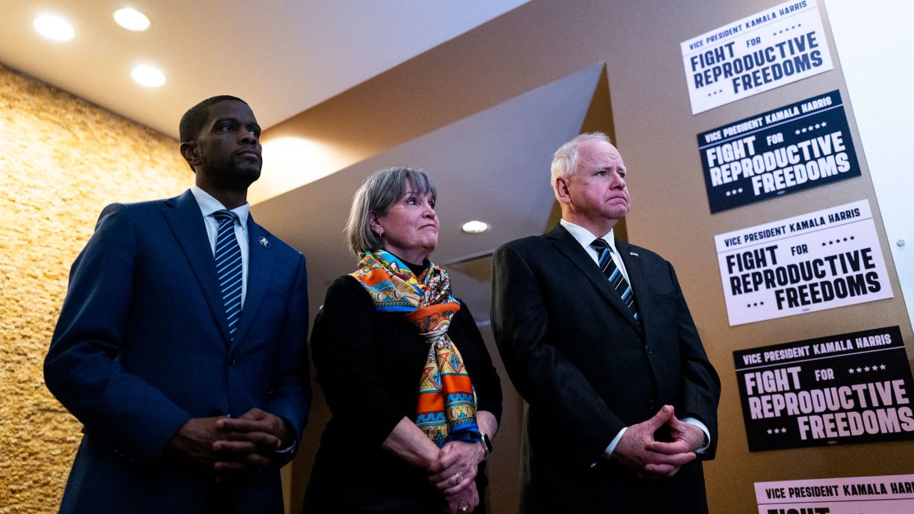 In this March 14 photo, Minnesota Gov. Tim Walz, right, listens as Vice President Kamala Harris speaks during a visit to a Planned Parenthood clinic in Saint Paul, Minnesota.