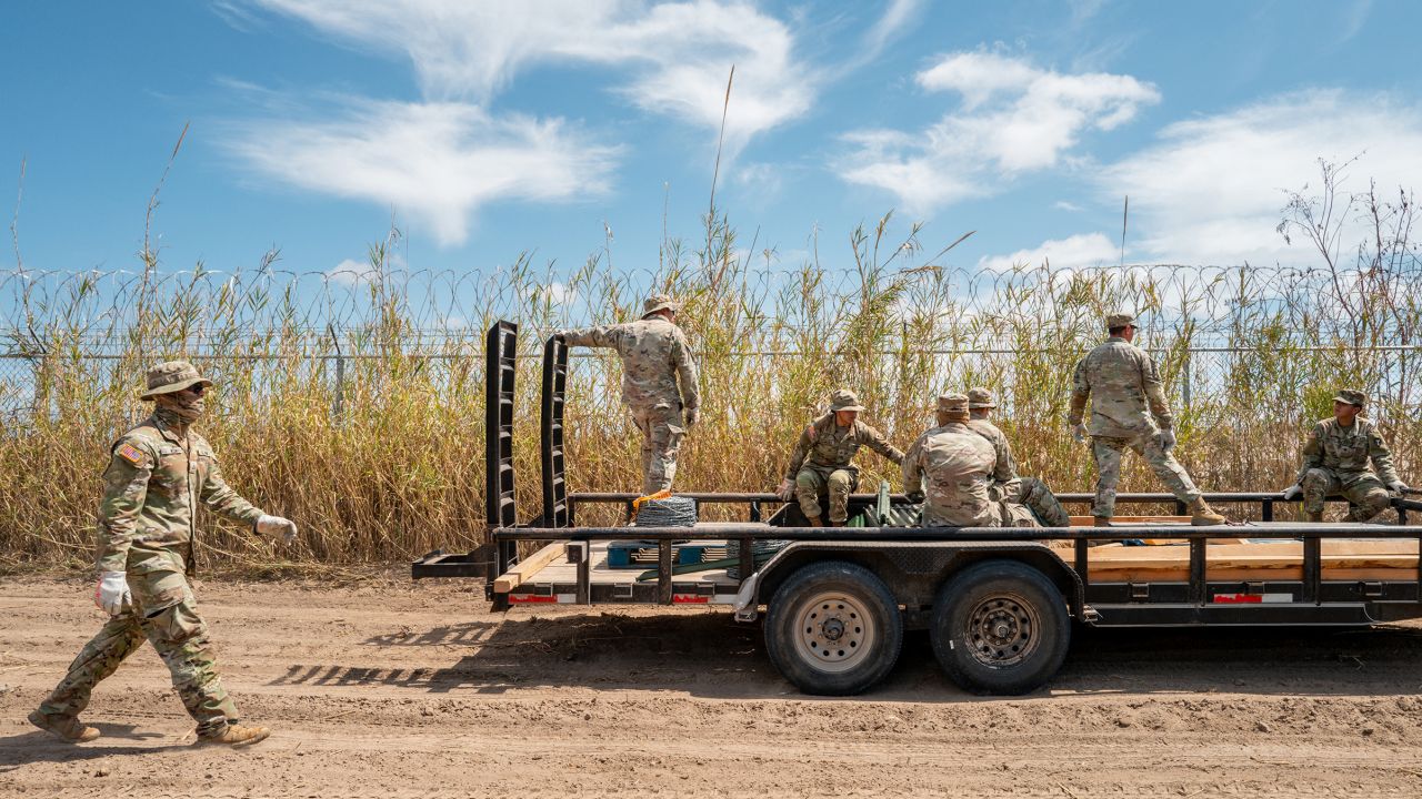 Texas National Guard soldiers lay material out in preparation to build and repair damaged fencing on the banks of the Rio Grande river near Shelby Park on March 21, in Eagle Pass, Texas. 