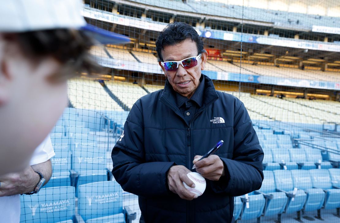 Former Los Angeles Dodgers pitcher Fernando Valenzuela signs autographs for fans before the game against the San Francisco Giants at Dodger Stadium on April 1 in Los Angeles.