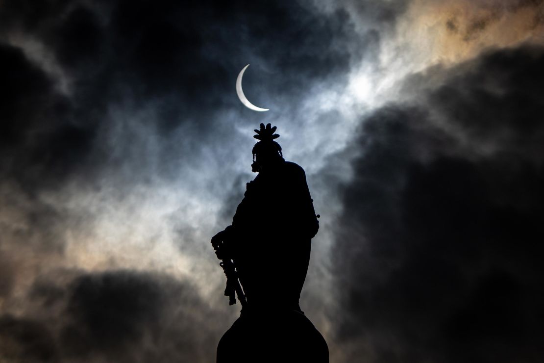 The partial solar eclipse is seen above the Statue of Freedom atop the dome of the US Capitol Building on Capitol Hill on April 8 in Washington, DC. 