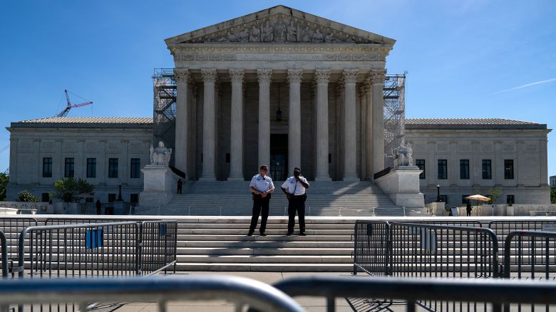 Supreme Court Police officers stand on the steps of the Supreme Court on April 16, in Washington, DC.