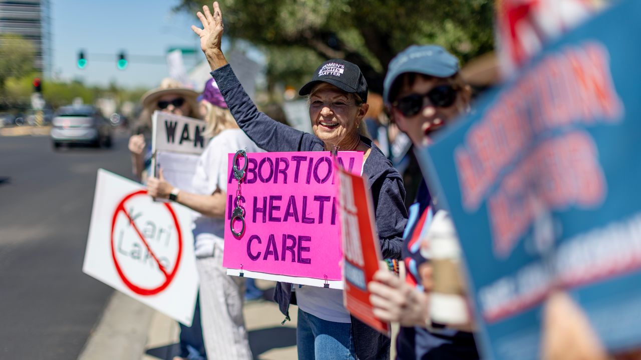 Arizona residents rally for abortion rights on a street corner Tuesday on the heels of the Arizona's Supreme Court decision enacting an 1864 law banning abortion on April 16, in Phoenix.