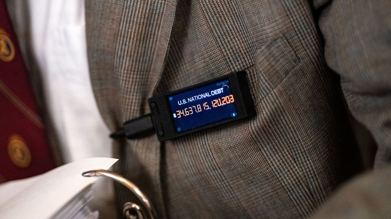 Rep. Thomas Massie wears a pin displaying a live tally of the national debt during a House Committee on Rules business meeting at the US Capitol on April 18, 2024 in Washington, DC.