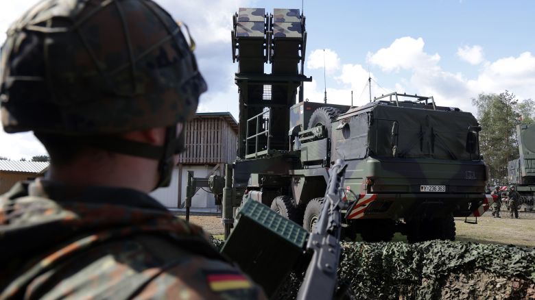 A reservist member of a Homeland Protection unit of the Bundeswehr, the German armed forces, stands next to a launcher of a Patriot missile system during the "National Guardian" military exercise at the Bundeswehr's tank training grounds on April 18, 2024 in Munster, Germany. 