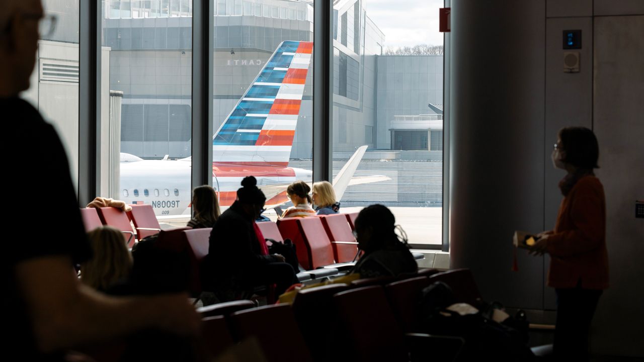 Passengers wait to board an American Airlines flight from Terminal B of LaGuardia Airport (LGA) in the Queens borough of New York, on Sunday, April 7. 