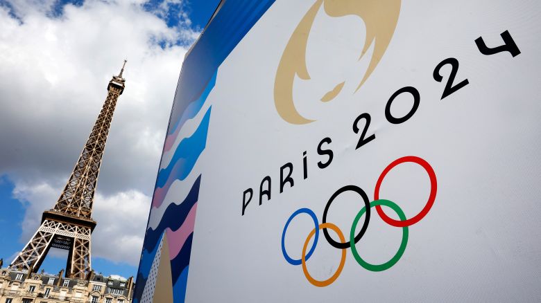 The Paris 2024 logo, representing the Olympic Games is displayed near the Eiffel Tower three months prior to the start of the Paris 2024 Olympic and Paralympic games on April 21, 2024 in Paris, France.