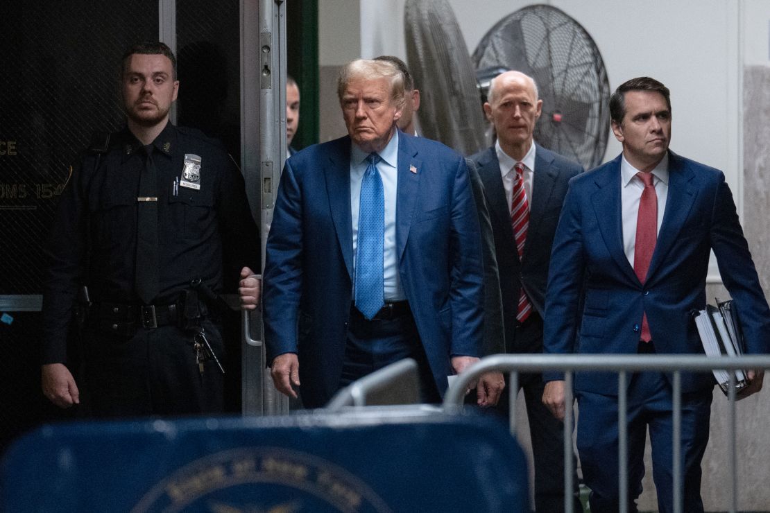 Former President Donald Trump arrives with attorney Todd Blanche and Sen. Rick Scott for his trial for allegedly covering up hush money payments at Manhattan Criminal Court on May 9, in New York City.