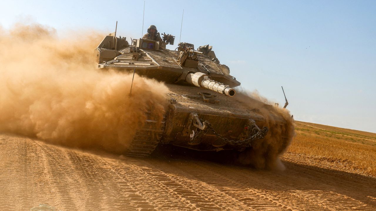 An Israeli army battle tank moves near the border with the Gaza Strip at a location in southern Israel on May 13, amid the ongoing conflict in the Palestinian territory between Israel and the Hamas movement.