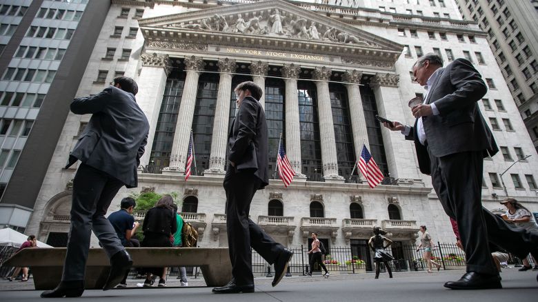 Pedestrians in front of the New York Stock Exchange (NYSE) in New York, on Friday, June 7.
