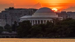 The rising sun peaks over the top of the Jefferson Memorial on a hot summer day on June 18, 2024, in Washington, DC.