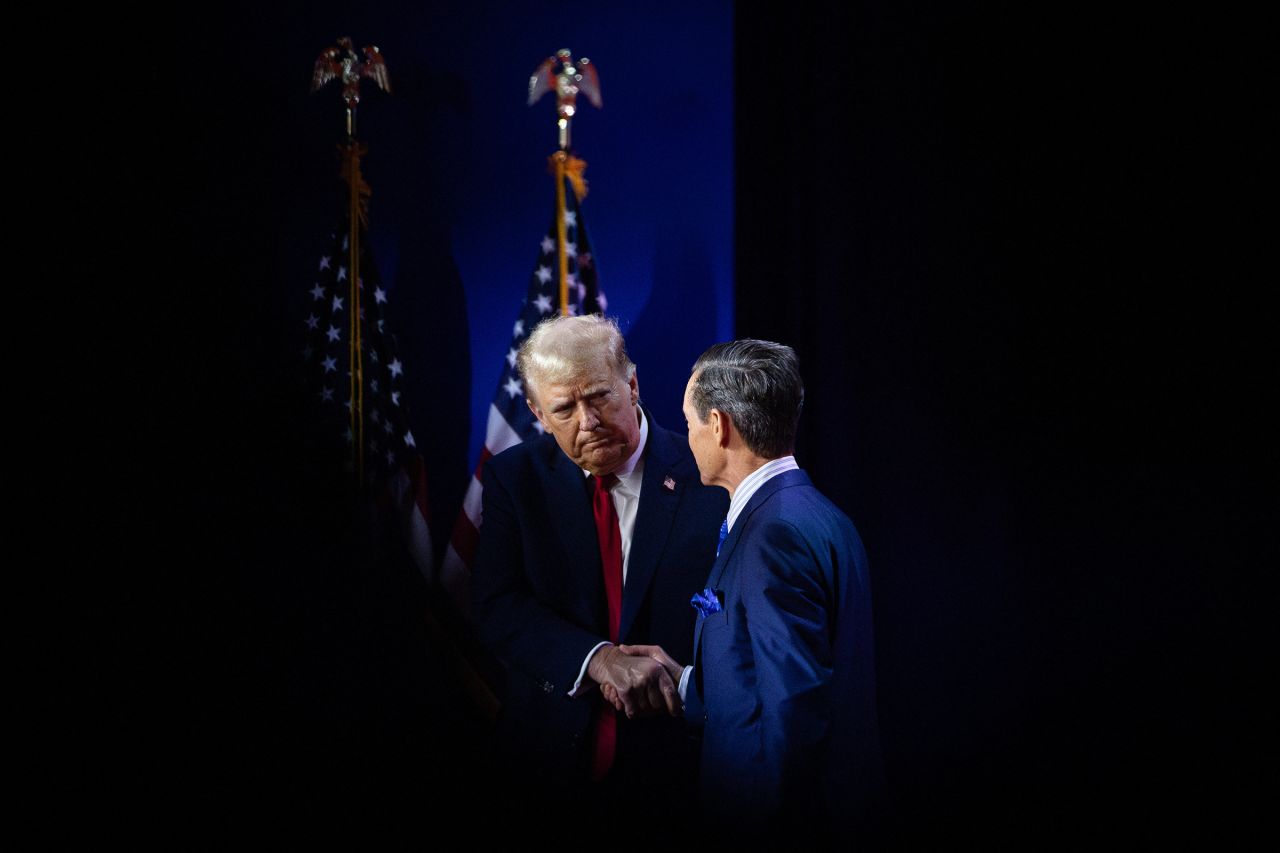 Former President Donald Trump shakes hands with Faith and Freedom Coalition Executive Director Ralph Reed prior to speaking at the organization's annual Road to Majority conference in Washington, DC, on June 22. 