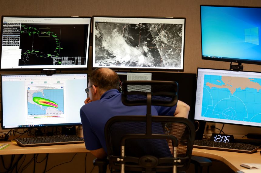 This July 2024 photo shows a hurricane specialist at the National Weather Service's hurricane center in Miami.