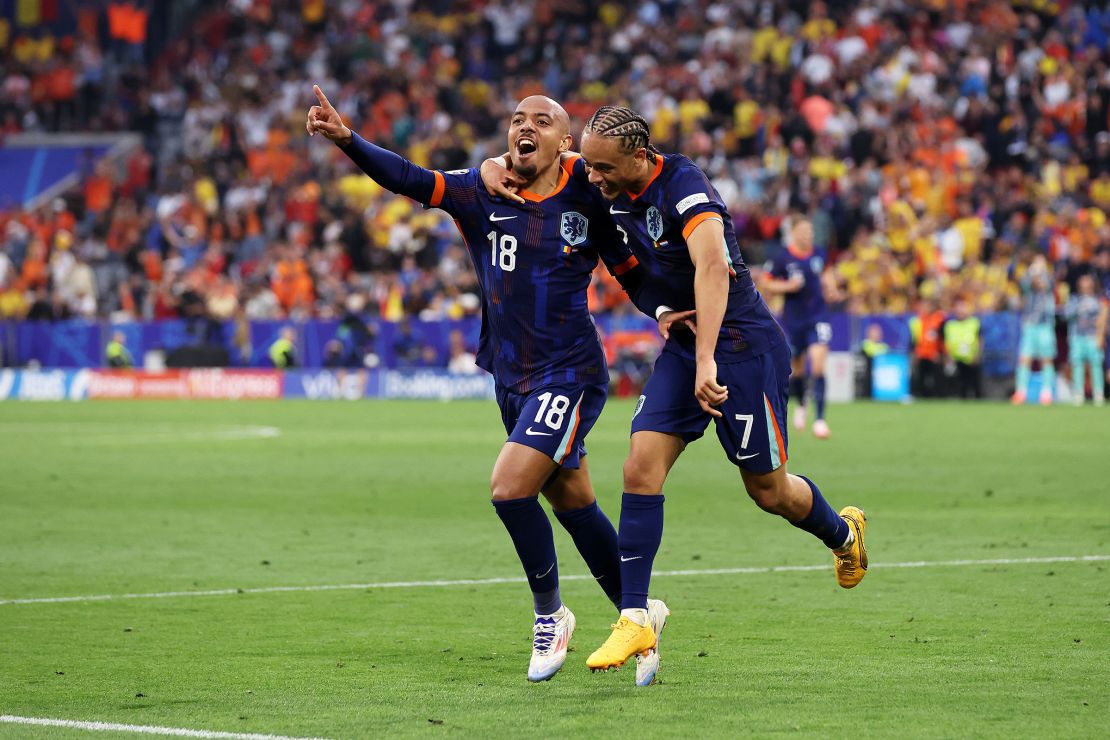 Malen (left) celebrates with his teammate Xavi Simons after scoring the Netherlands' third goal against Romania.