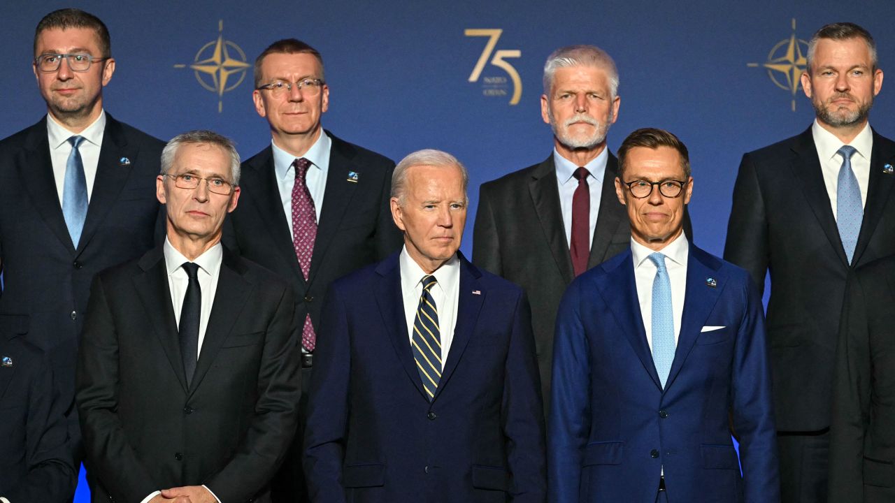 President Joe Biden, flanked by NATO Secretary General Jens Stoltenberg, left, and President of Finland Alexander Stubbs, right, stands with NATO leaders for a group photo during the NATO 75th Anniversary Celebratory Event at the Mellon Auditorium in Washington, DC, on July 9.