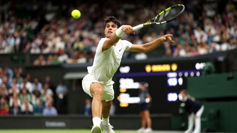 Carlos Alcaraz of Spain plays a backhand against Ugo Humbert of France in his Gentleman's Singles fourth round match during day seven of The Championships Wimbledon 2024 at All England Lawn Tennis and Croquet Club on July 7 in London.