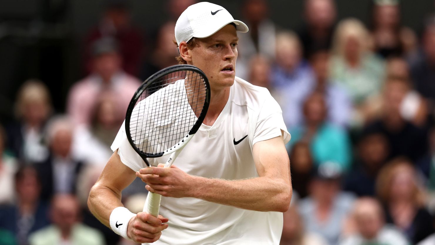 Jannik Sinner of Italy plays a backhand against Daniil Medvedev in the Gentlemen's Singles Quarter Final match during day nine of The Championships Wimbledon 2024 at All England Lawn Tennis and Croquet Club on July 09, 2024 in London, England.
