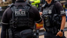 Members of the Secret Service stand guard as workers put up additional security fencing around the White House on July 24 in Washington, DC.