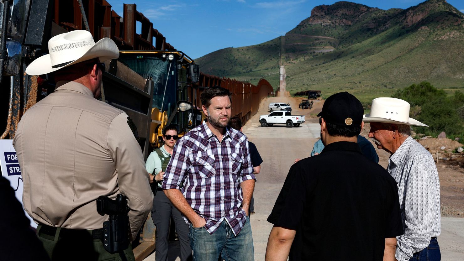 Sen JD Vance talks with Sheriff Robert Watkins of Cochise County President of the National Border Patrol Council Paul A Perez and local ranchers while touring the US Border Wall on August 1 in in Montezuma Pass Arizona