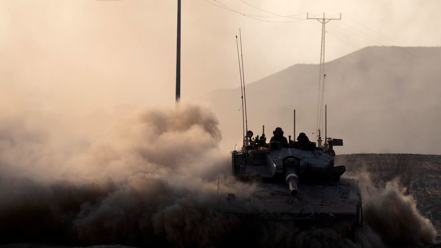 Israeli soldiers ride in a tank along the border with the Gaza Strip on August 7, 2024.