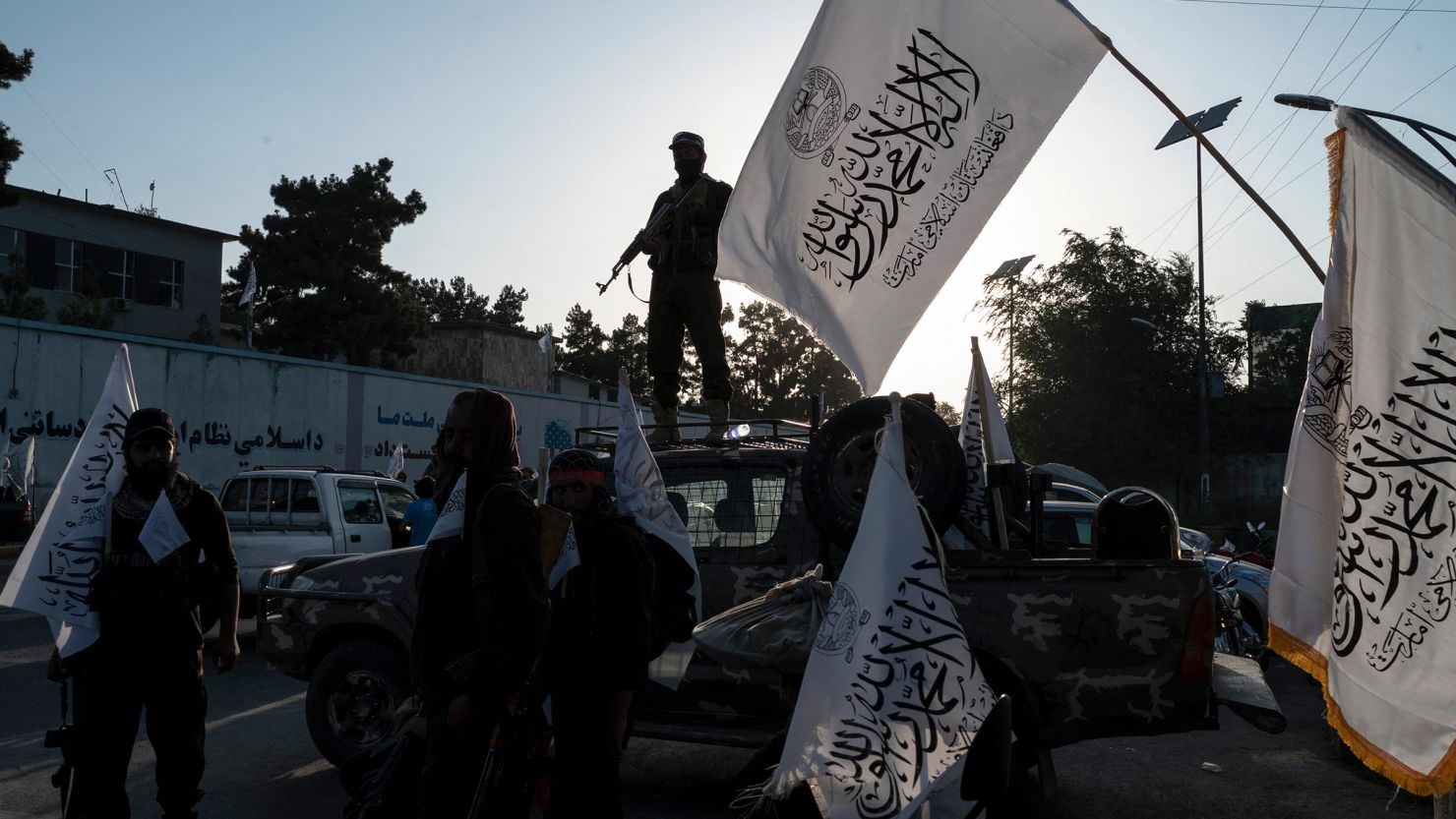 Taliban security personnel ride on a vehicle as they celebrate the third anniversary of Taliban takeover of Afghanistan near the Ahmad Shah Massoud square in Kabul on August 14.
