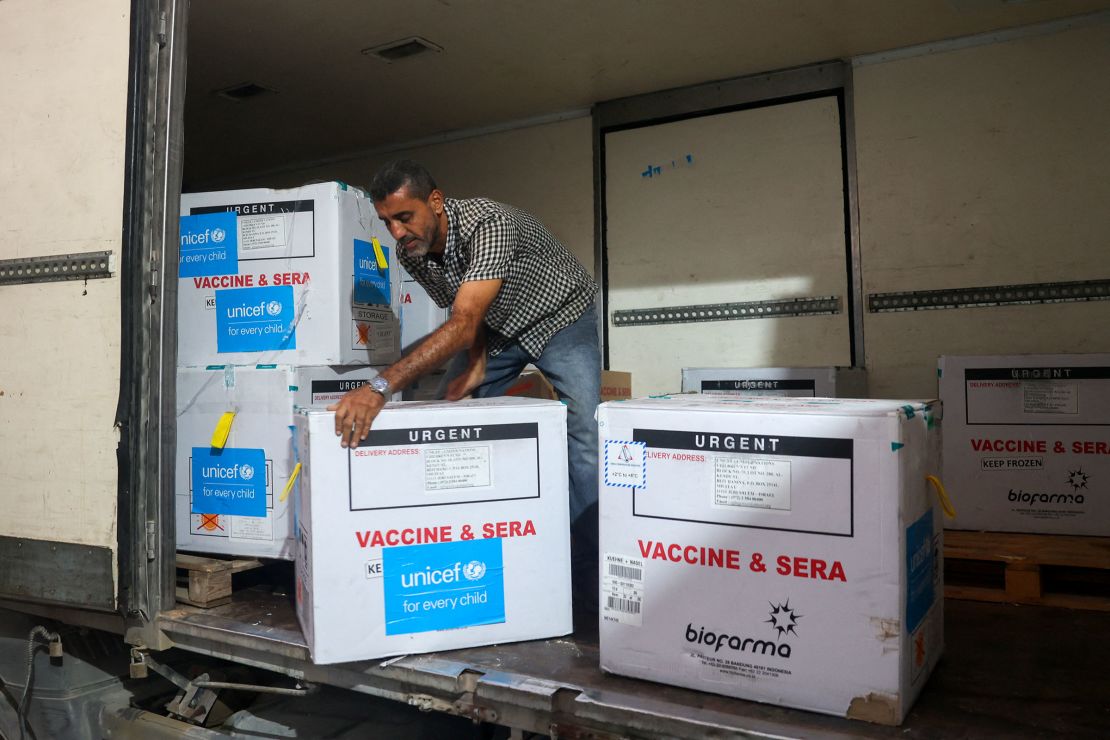 A worker unloads a shipment of polio vaccines through the Karm Abu Salem crossing at a Gaza health ministry depot, on Sunday.