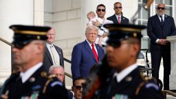 Former President Donald Trump observes a changing of the guard at the Tomb of the Unknown Soldier alongside Arlington National Cemetery Deputy Chief of Staff Bob Quackenbush at the Arlington National Cemetery on August 26, 2024 in Arlington, Virginia. 