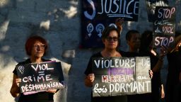 Demonstrators hold placards during a protest outside the courthouse during the trial of a man accused of drugging his wife for nearly ten years and inviting strangers to rape her at their home in Mazan, a small town in the south of France, in Avignon, on September 2, 2024.