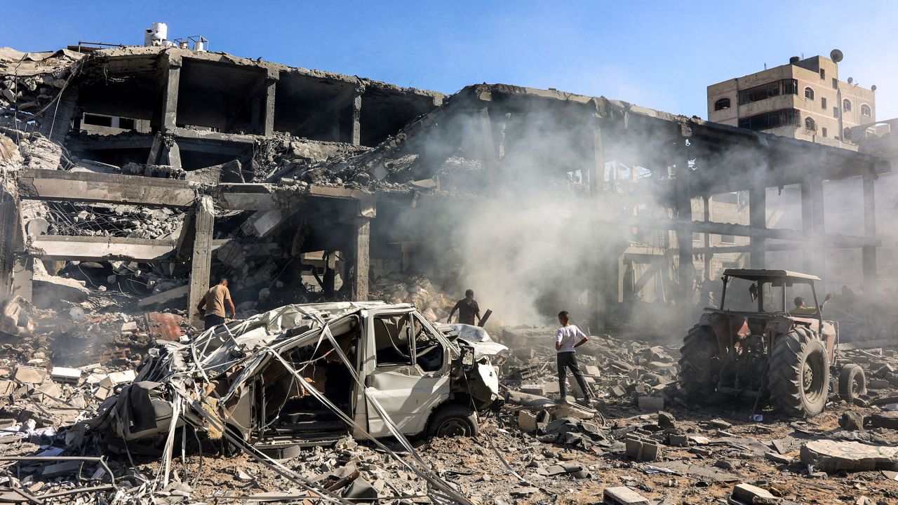 Men walk through debris in a building that was hit by Israeli bombardment in the Sheikh Radwan neighbourhood in the north of Gaza City on September 3.