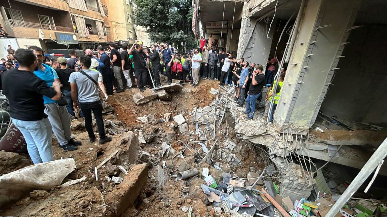 People check the damage at the scene of an Israeli strike in Beirut's southern suburbs on September 20.