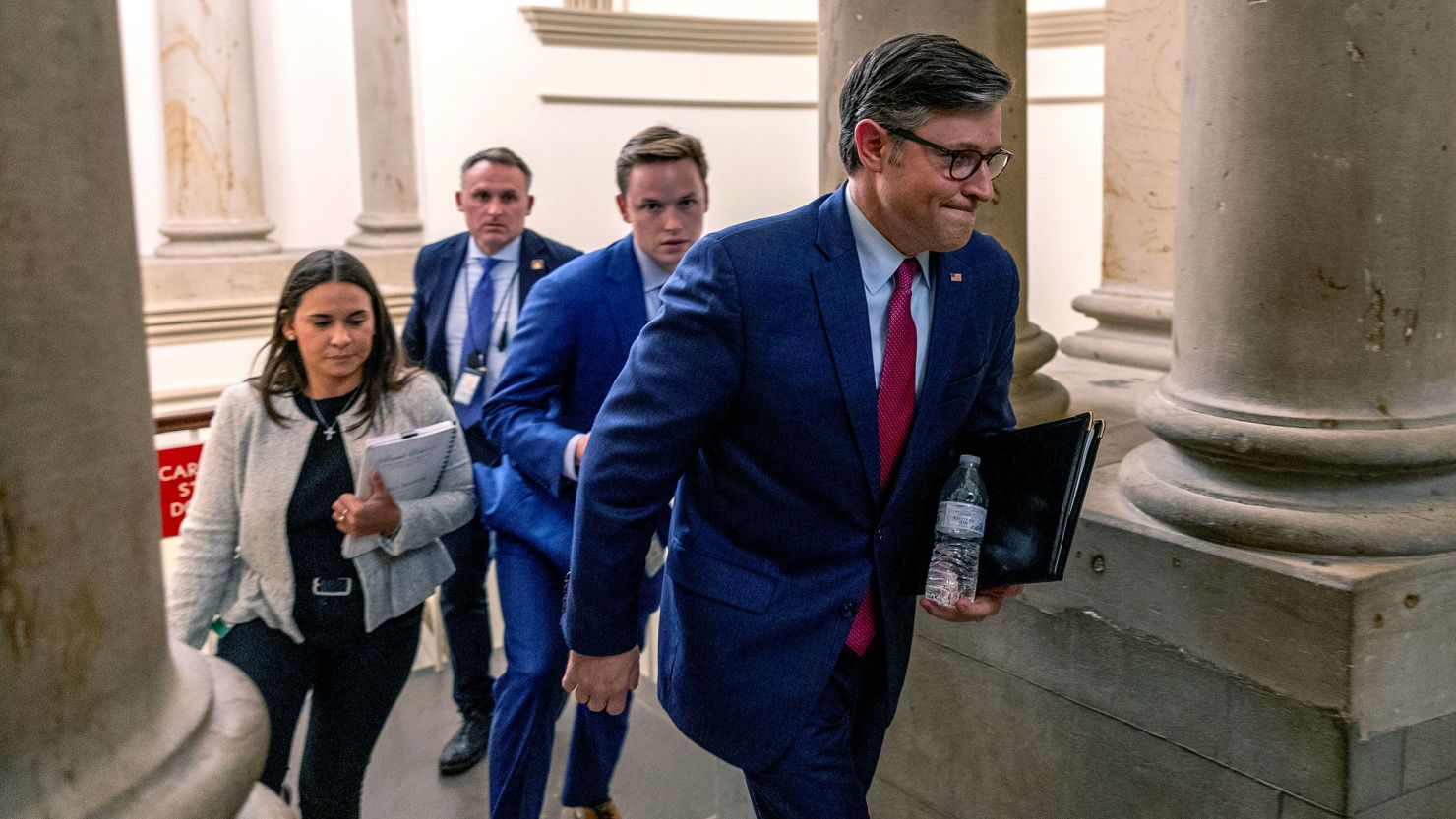 House Speaker Mike Johnson heads to his office before the vote on the government funding bill at the US Capitol on September 18, in Washington, DC.