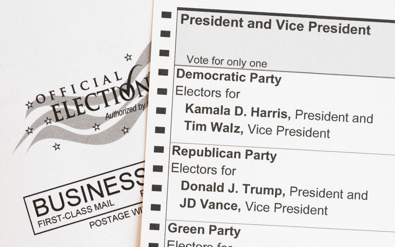 In this photo illustration, an absentee voter mail-in ballot shows the names of the presidential and vice presidential candidates for the November 5 US general election, including Democratic party candidates Vice President Kamala Harris and her running mate, Minnesota Governor Tim Walz, and Republican party candidate former President Donald Trump and his running mate, Ohio Senator JD Vance, on September 25, 2024 in Arlington, Virginia.