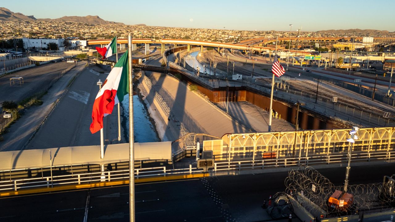 From an aerial view the Mexican and American flags fly over the Rio Grande at the US-Mexico border on September 18, 2024 in El Paso, Texas. 